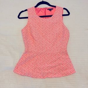 Pink and white geometric peplum top.